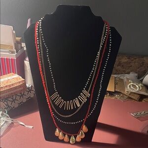 Plunder Red Bead Layered Necklace with Gold Accents and a gold bracelet